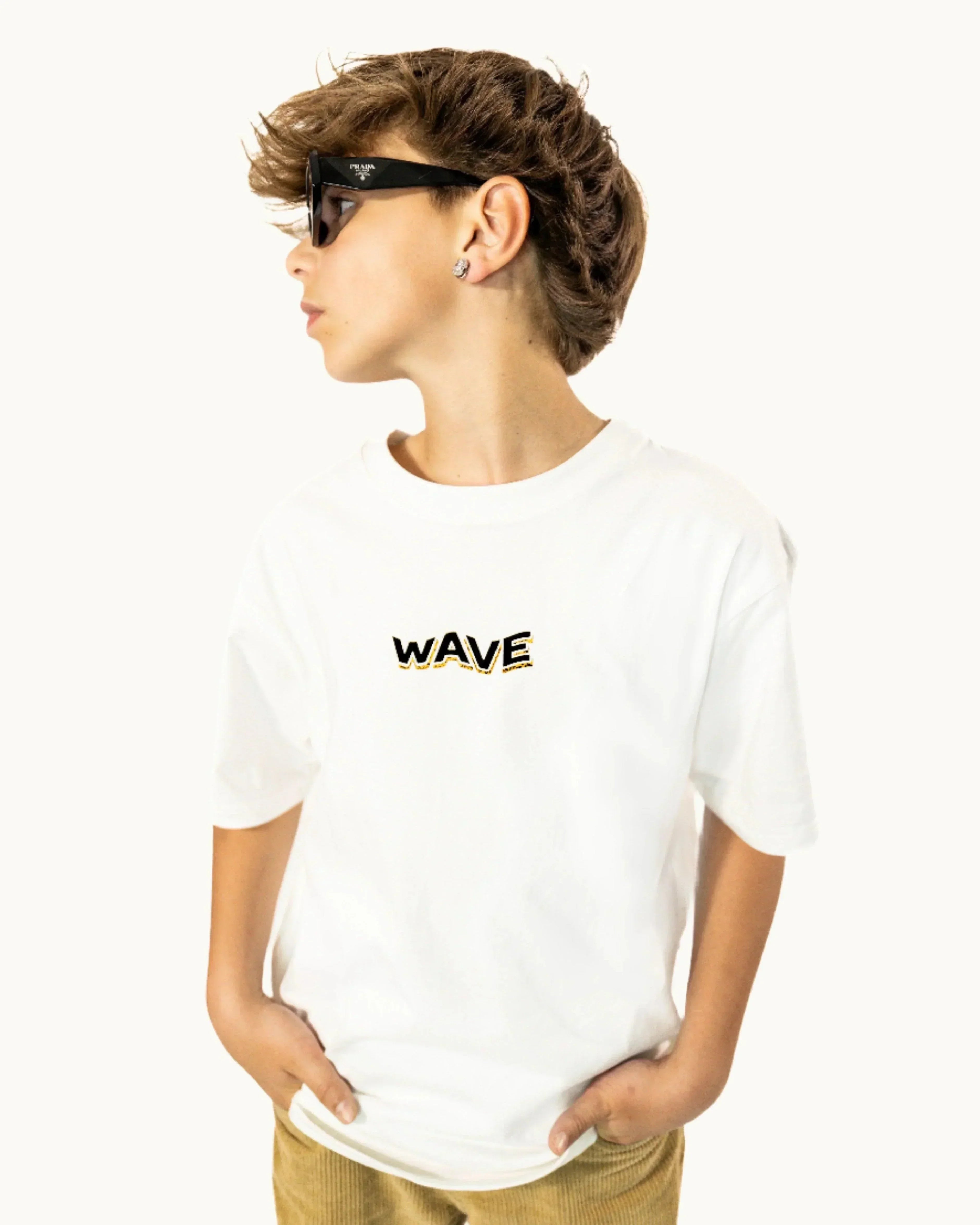 Boy wearing sunglasses and white t-shirt with 'WAVE' text on front