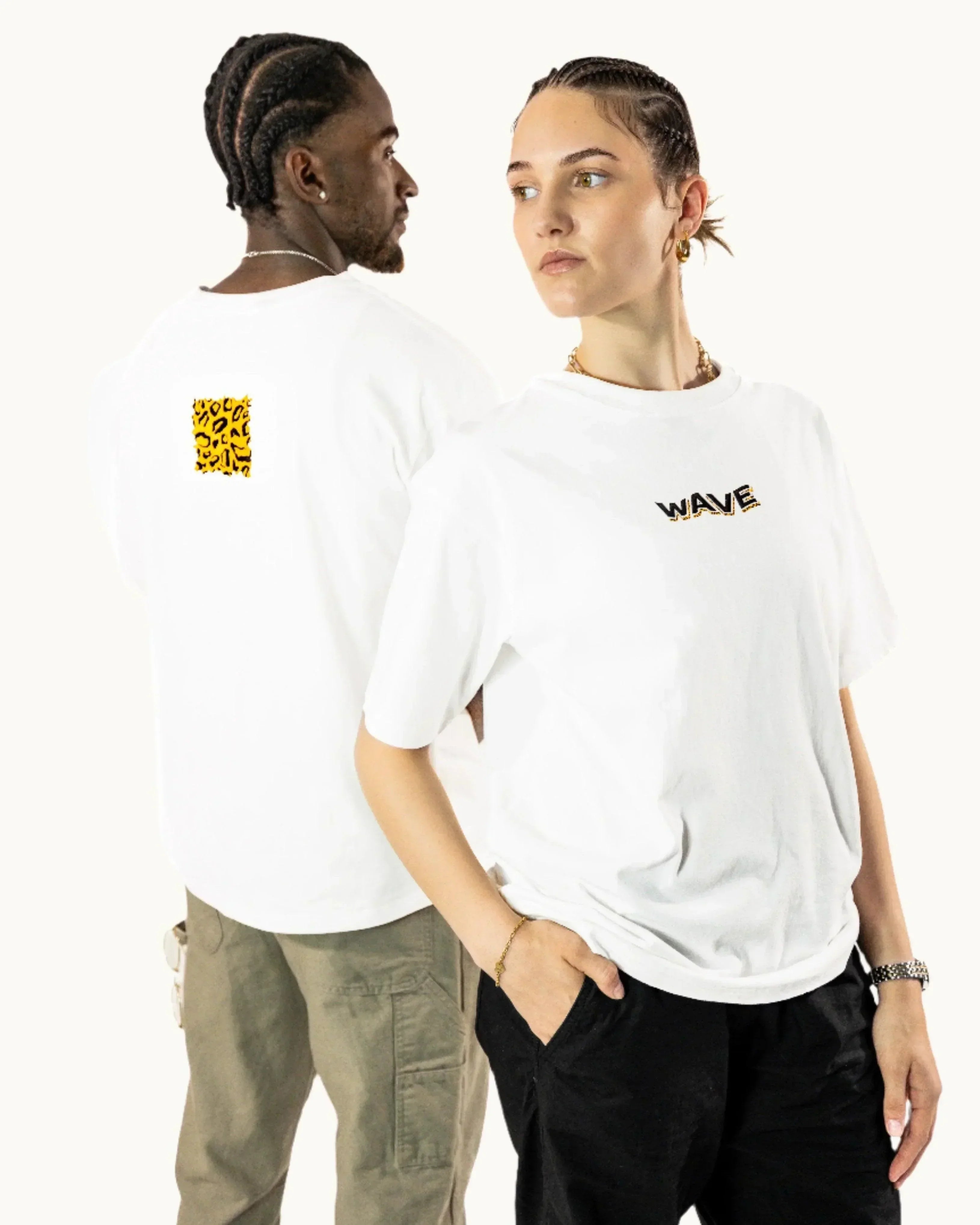 Two models wear white WAVE t-shirts with leopard print accents, standing against white background.