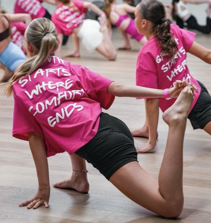Dancers wearing pink printed Vertex event tees